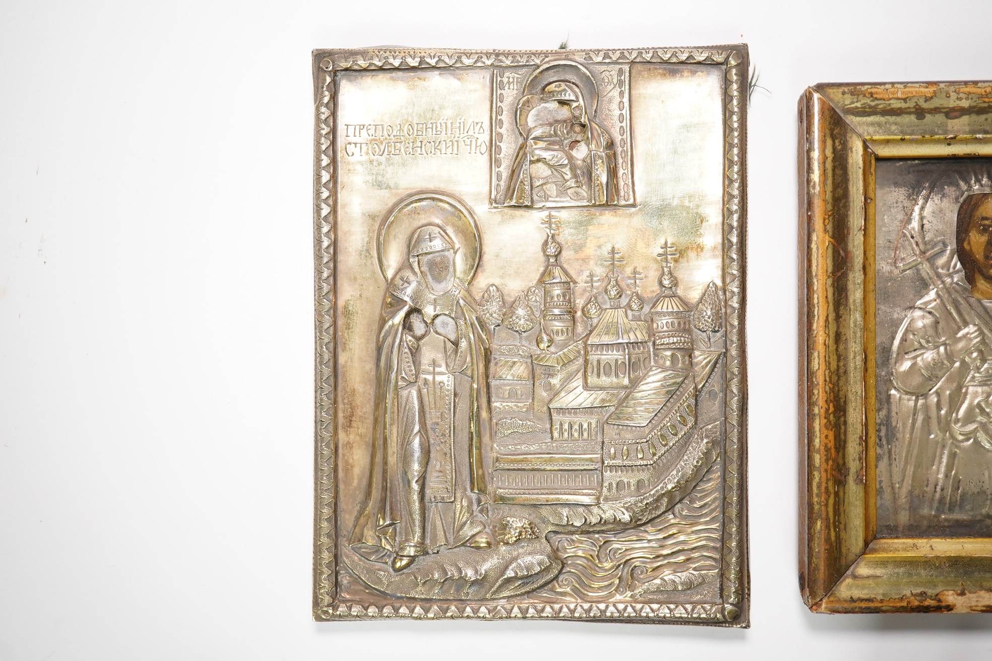 An 18th/19th century Russian silver overlaid icon together with another, largest 12 x 9cm. Condition - fair